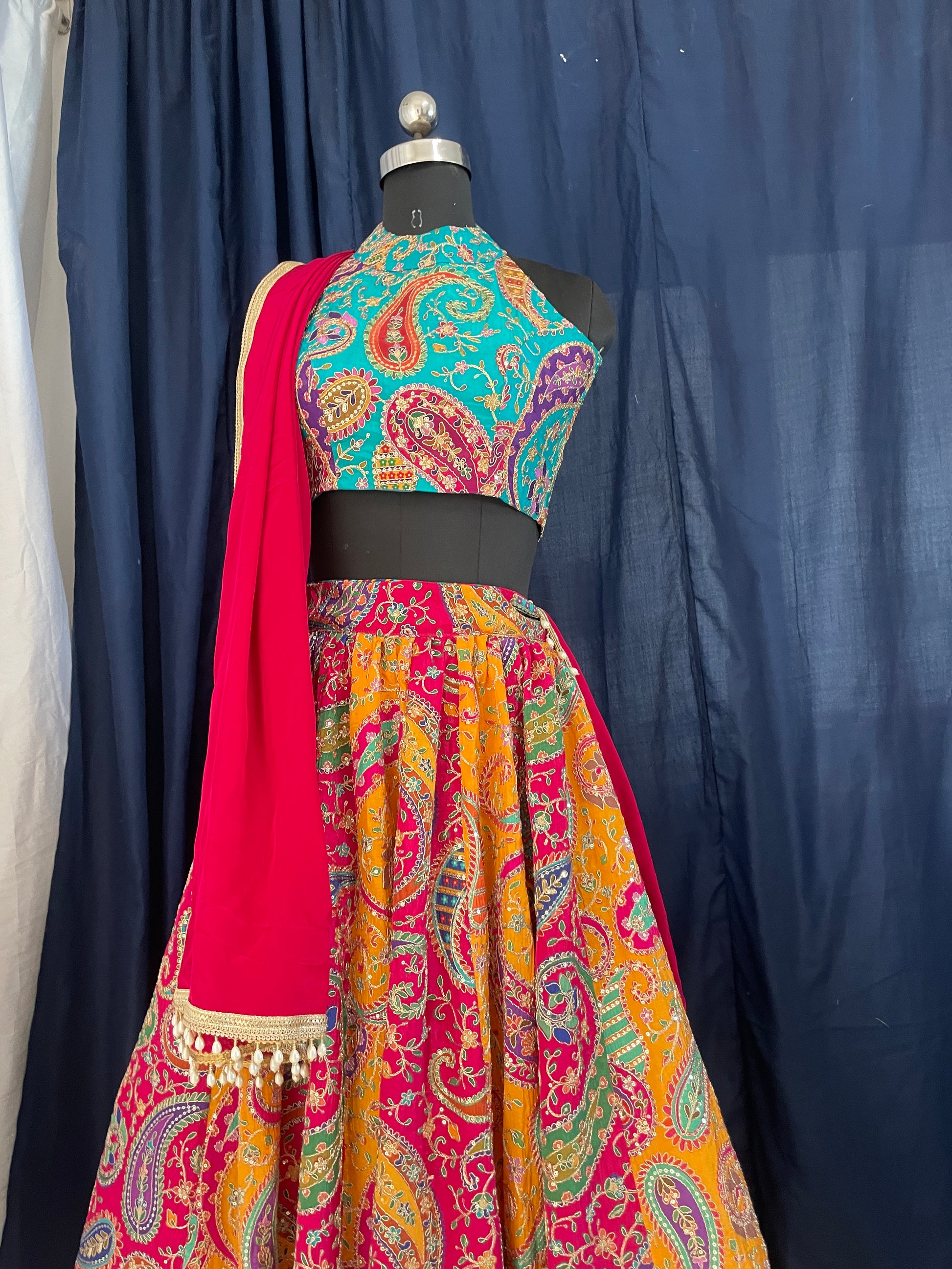 Colorful traditional garment with intricate patterns on a dark background